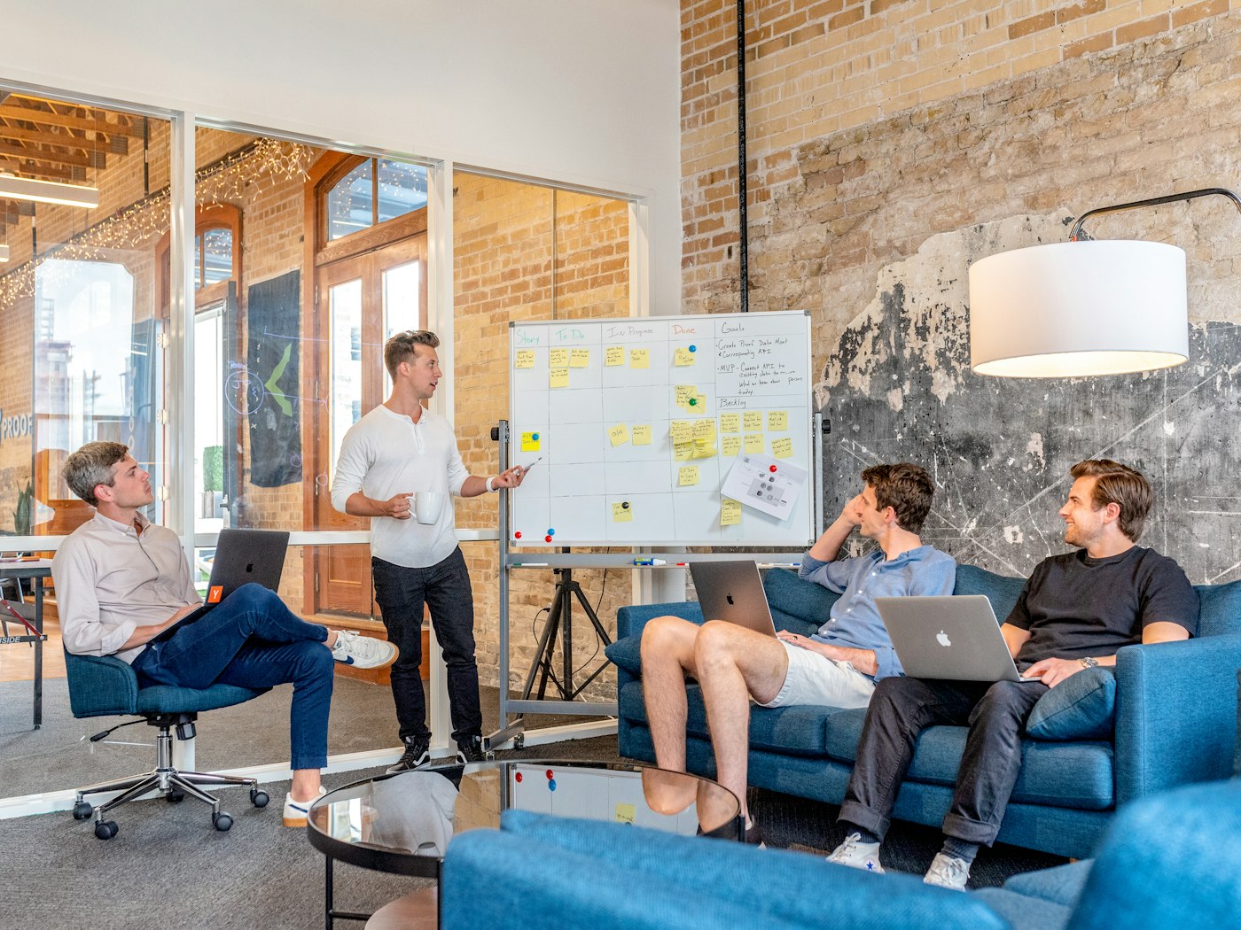 A team workshop: one person leads a planning session at a whiteboard